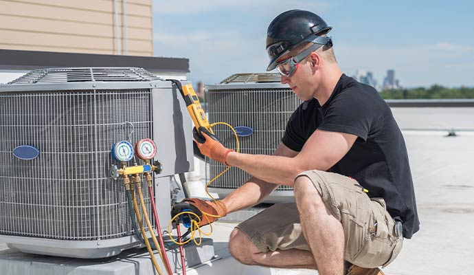 HVAC technician servicing air conditioner
