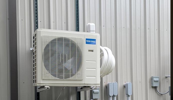 MrCool outdoor heat pump mounted on metal wall