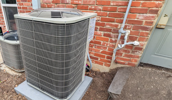 Outdoor AC units beside brick wall Outdoor AC units beside brick wall