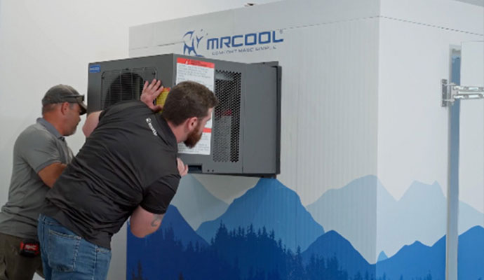 Technicians installing a MRCOOL reach-in cooler refrigeration unit