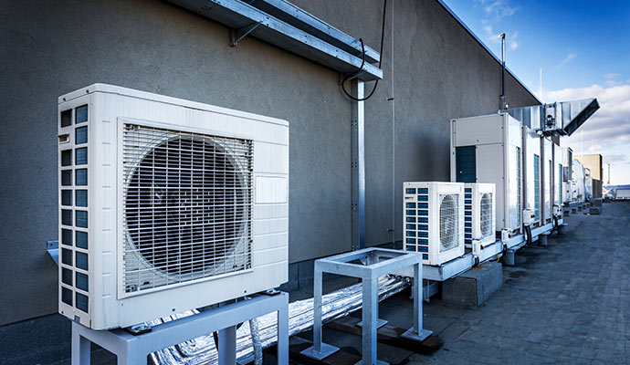 Row of outdoor AC units on a rooftop
