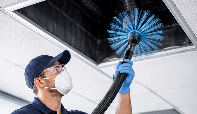 Technician cleaning air ducts