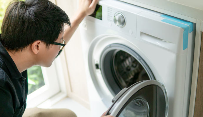 Technician inspecting washing machine