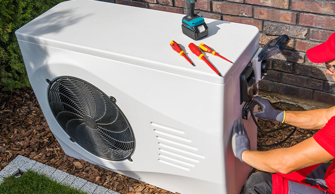 Technician repairing outdoor ac unit