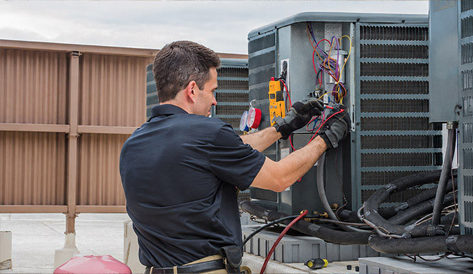 Technician servicing a rooftop AC