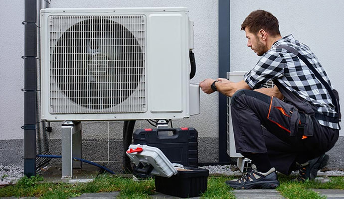 Technician servicing an outdoor AC