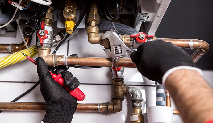 Technician working on boiler pipes