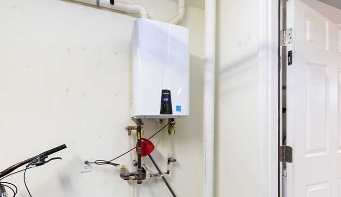 A wall mounted tankless water heater system